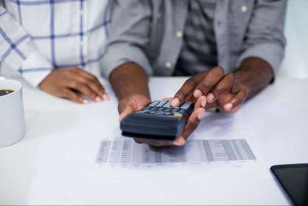 Two people using calculator 