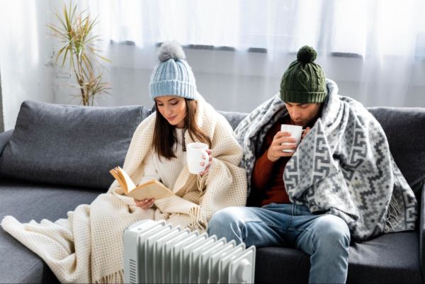 Couple Bundled Up on Couch Cold
