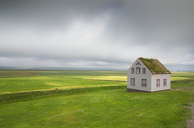 House sitting in a large field 