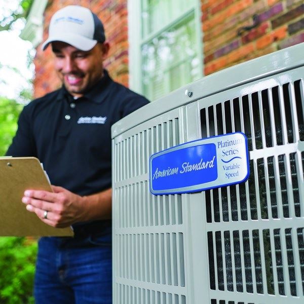 Technician Installing AC Unit 