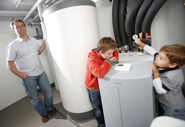 Family standing around heat pump system 