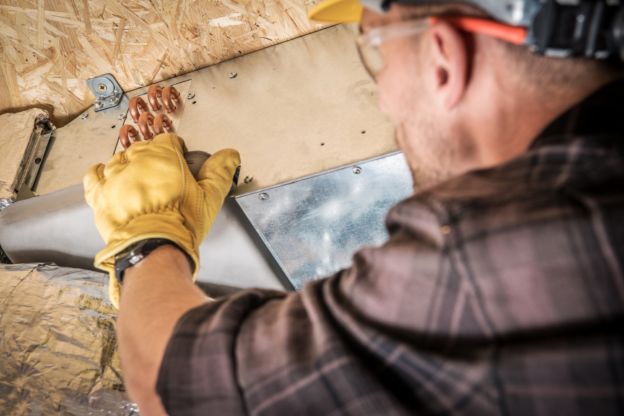 Technician Installing Ductwork 