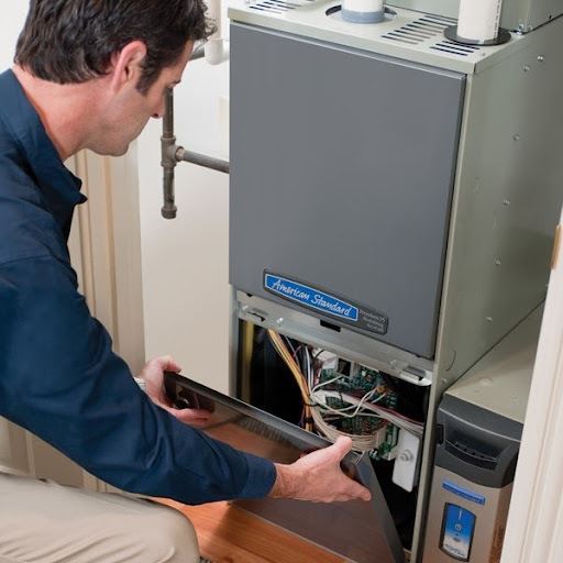 Technician Installing Heating System 